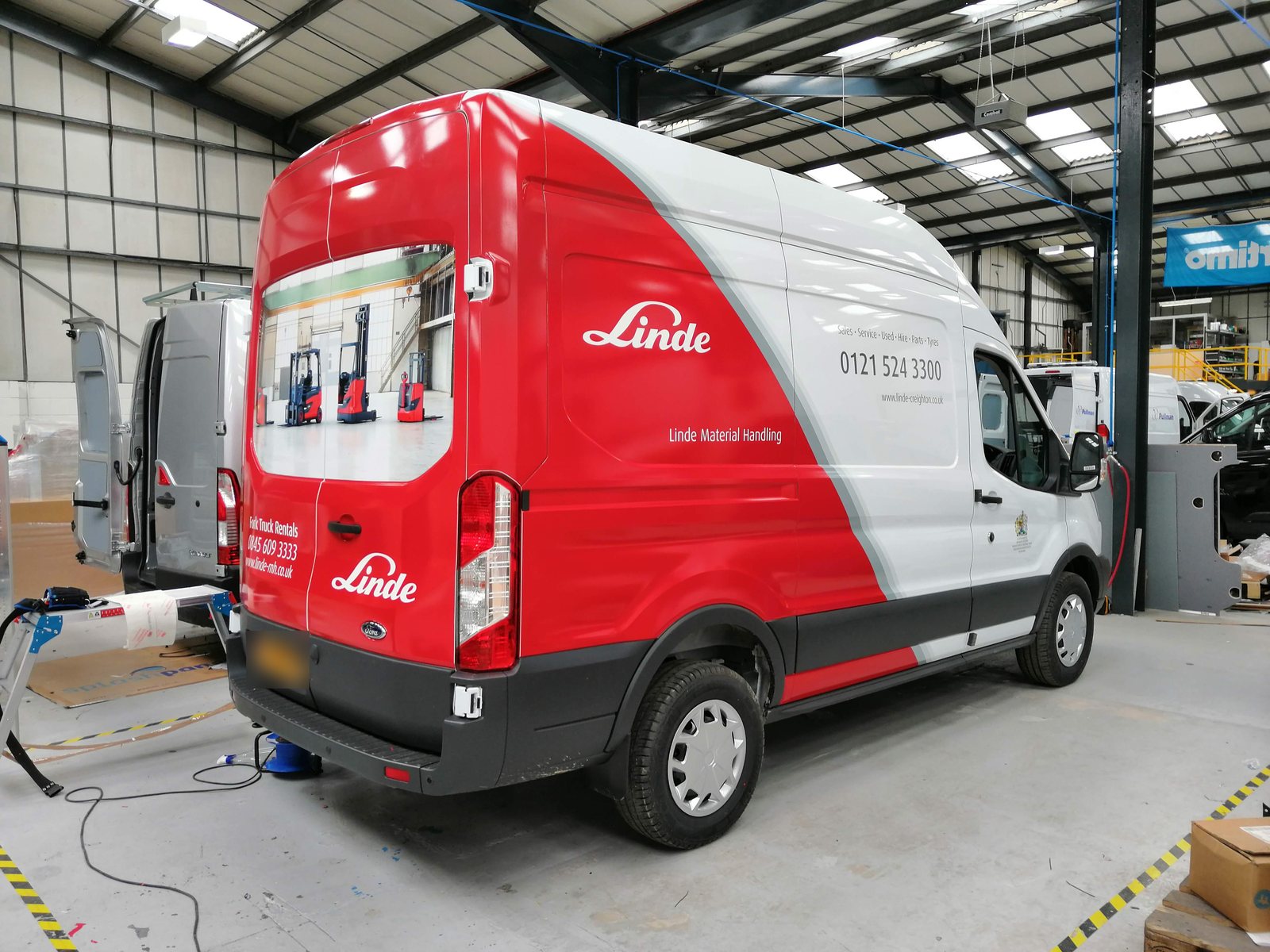 Van wrapped in red and white vinyl livery
